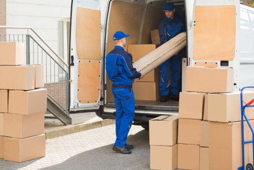 Driver and moving team preparing boxes safely before a van relocation