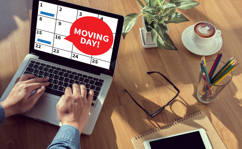 Removal professionals handling desks and office furniture for a commercial relocation